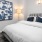 Bedroom with large bed, ensuite. queen bed and nightstands.