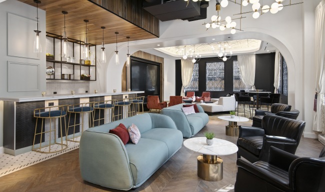 Clubhouse Resident clubhouse with ample seating, fireplace, demo kitchen and TVs